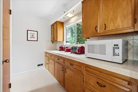 a kitchen with stainless steel appliances granite countertop a sink dishwasher stove and cabinets with wooden floor