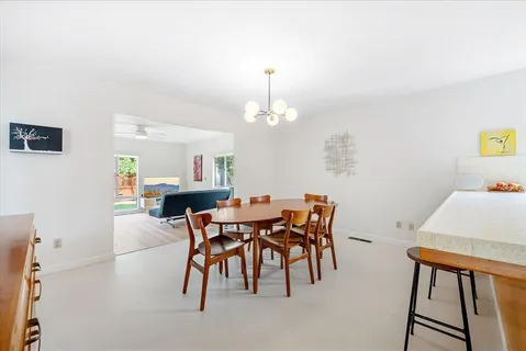 a view of a dining room with furniture and chandelier