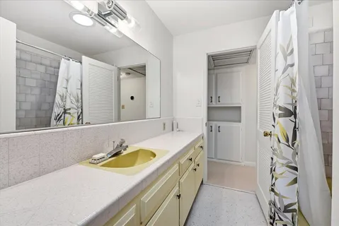 a bathroom with a sink a vanity and a mirror