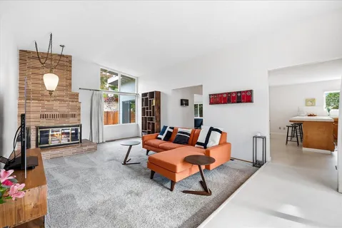 a living room with furniture and a fireplace