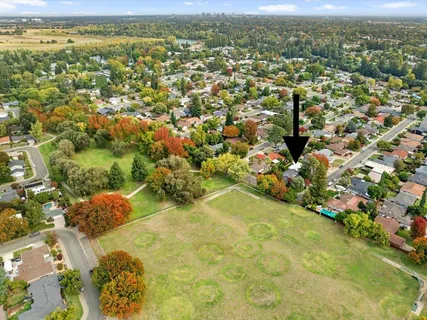 an aerial view of residential houses with outdoor space