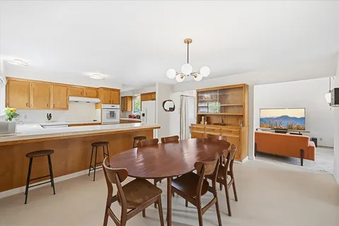 a dining room with furniture and window