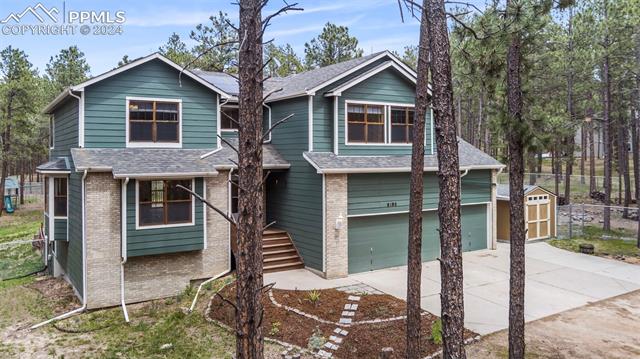 8180 Tannenbaum Road Colorado Springs, CO 80908 - Photo 2 of 11 View of front of home featuring a 3-car garage and a storage shed