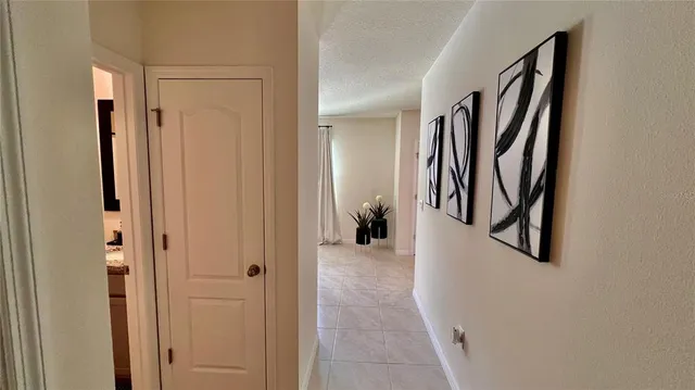 a view of a hallway with wooden floor and closet
