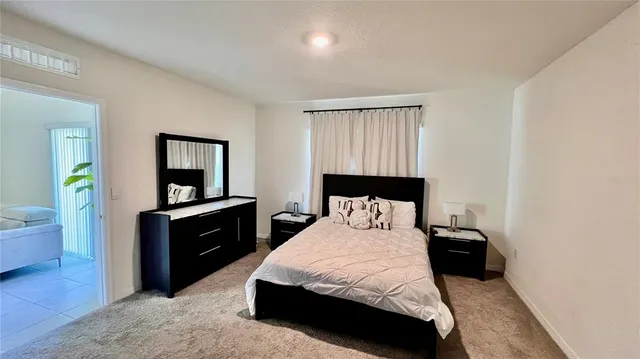 a bedroom with a bed and a dresser