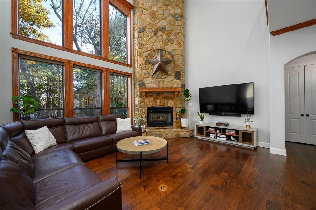 588 Lakepoint Loop Pottsboro, TX 75076 - Photo 14 of 39 a living room with furniture a flat screen tv and a large window