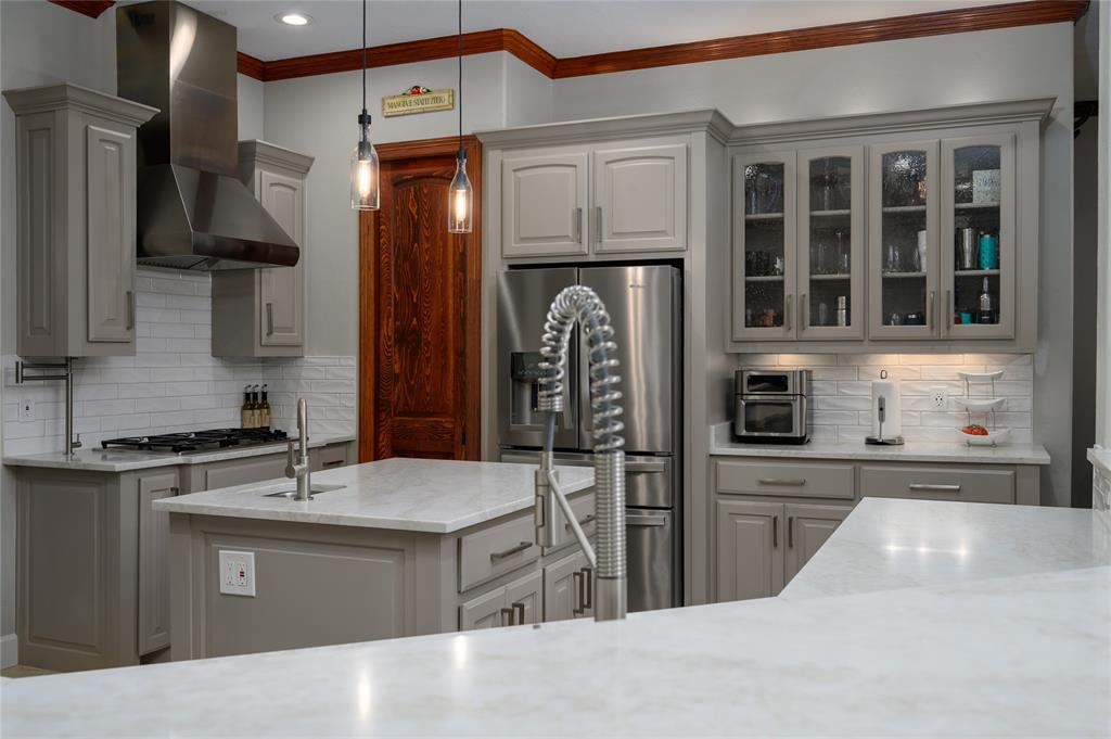 588 Lakepoint Loop Pottsboro, TX 75076 - Photo 16 of 39 a kitchen with stainless steel appliances granite countertop a sink and a stove