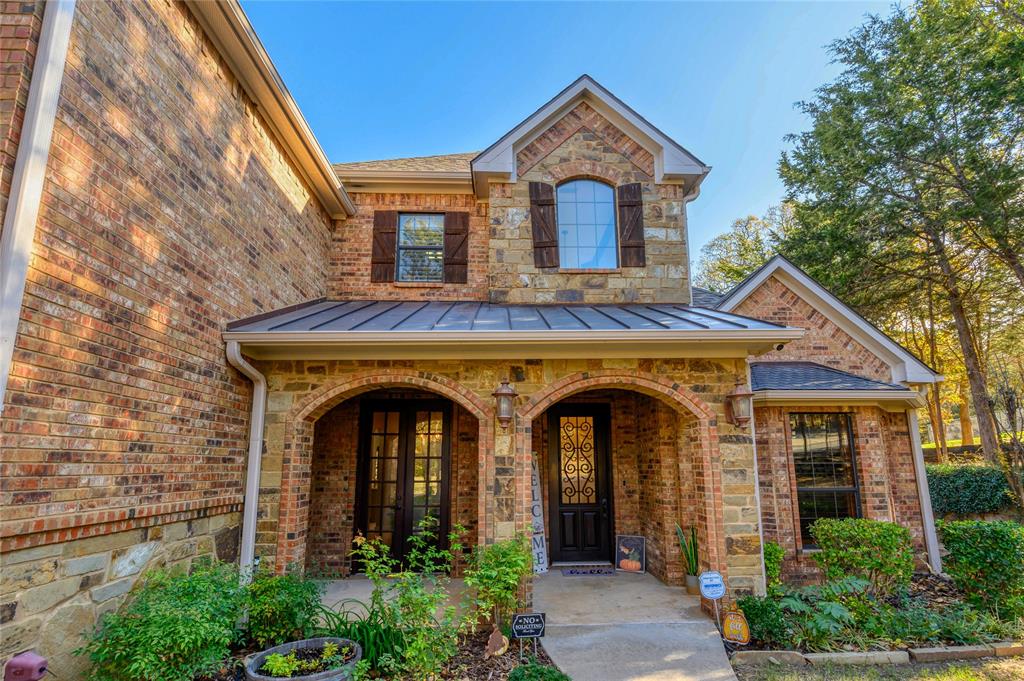 588 Lakepoint Loop Pottsboro, TX 75076 - Photo 5 of 39 a front view of a house with plants