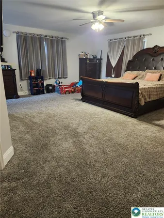 a living room with furniture a window and gym equipment