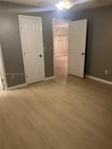 an empty room with closet area