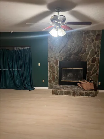 a view of an empty room with a fireplace