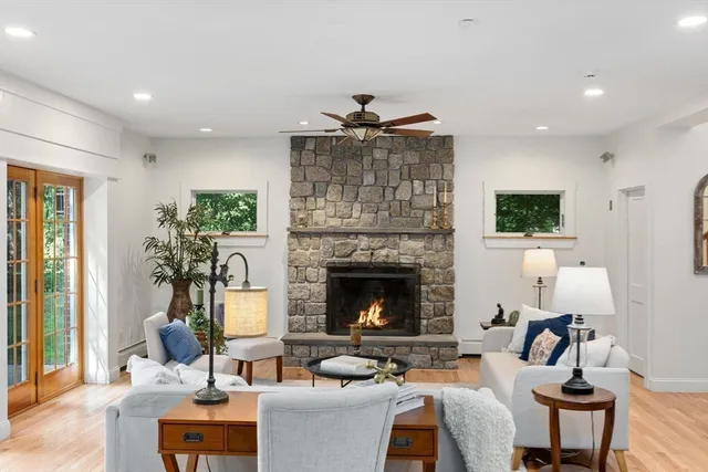a living room with furniture a fireplace and a flat screen tv