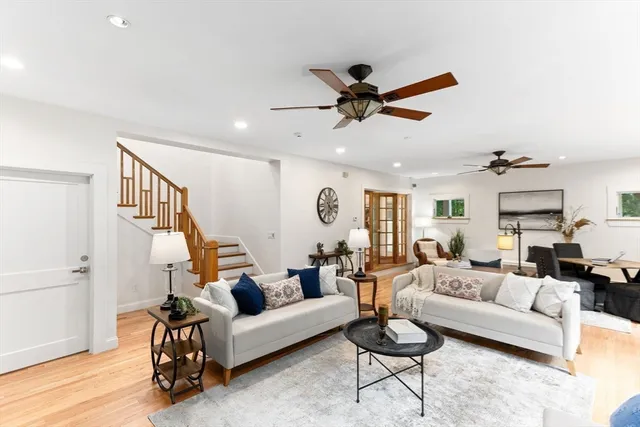 a living room with furniture and a wooden floor