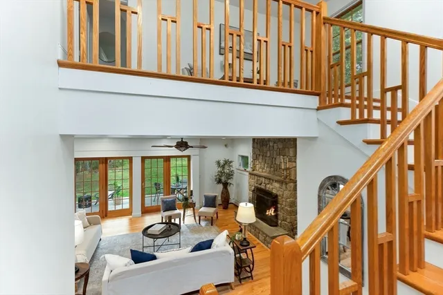 a living room with furniture a fireplace and a large window
