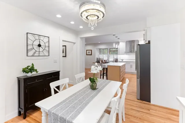 a dining room with furniture and a chandelier