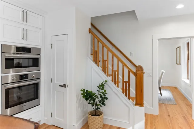 a view of an entryway with wooden floor and staircase
