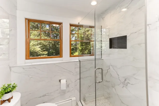 a bathroom with a window and a shower