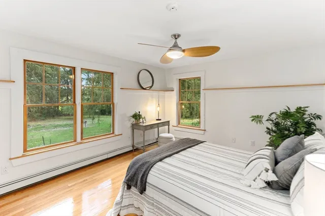 a bedroom with a bed and a large window with swimming pool in front of it