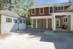 a view of a house with a yard and large tree