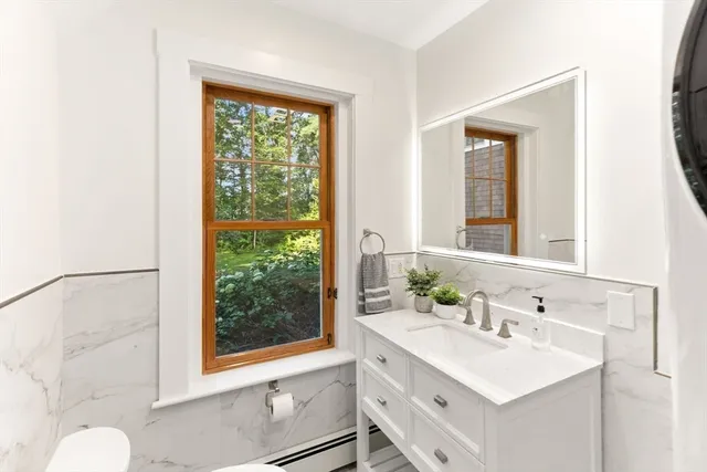 a bathroom with a sink vanity and a mirror