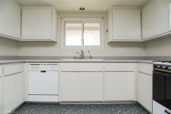 a kitchen with stainless steel appliances granite countertop a sink and a stove