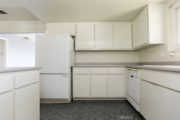 a kitchen with stainless steel appliances granite countertop a sink and a refrigerator