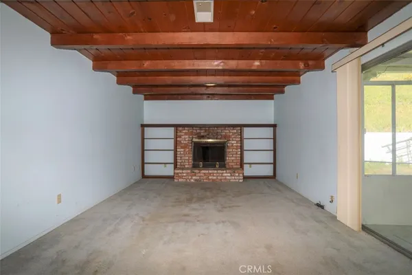 a view of empty room with entryway and a ceiling fan