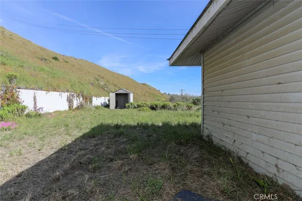 a view of a house with a yard and plants