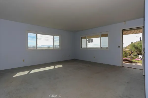 a view of empty room with a fireplace