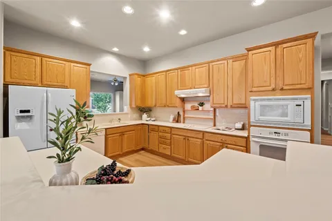 a kitchen with stainless steel appliances kitchen island granite countertop a sink and cabinets