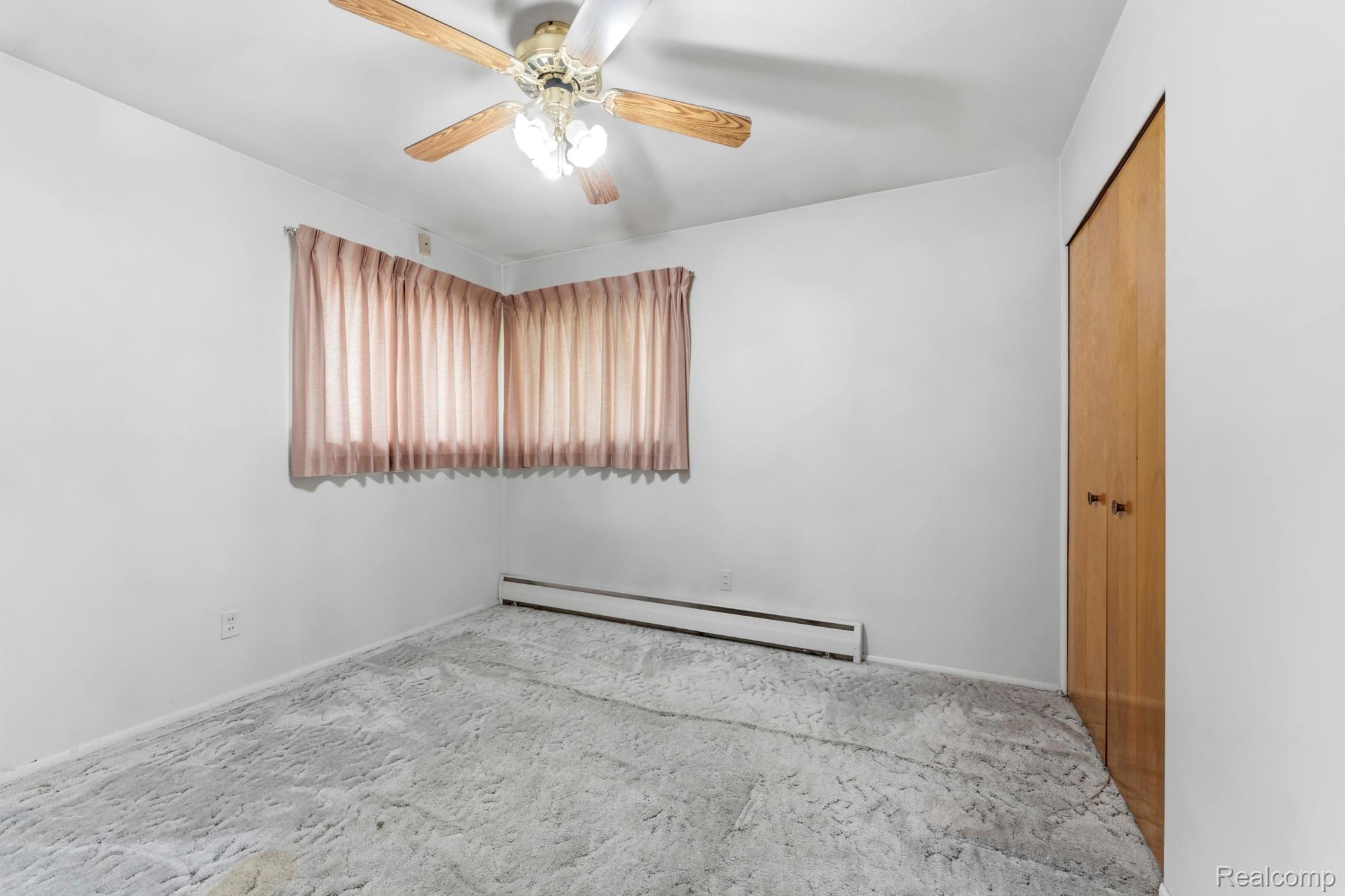 23410 Joy Road Redford, MI 48239 - Photo 15 of 25 Spare room featuring baseboard heating and ceiling fan