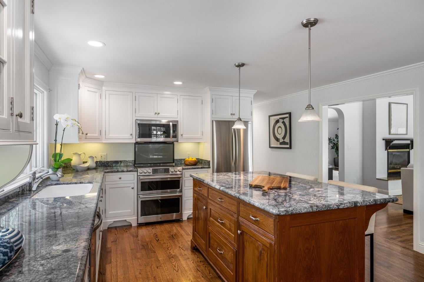 1585 Canada Lane Woodside, CA 94062 - Photo 13 of 46 a kitchen with kitchen island a counter top space appliances and cabinets