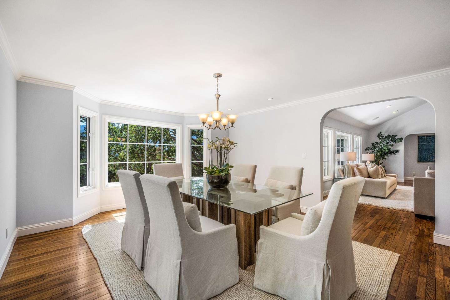 1585 Canada Lane Woodside, CA 94062 - Photo 18 of 46 a dining room with furniture wooden floor and a chandelier