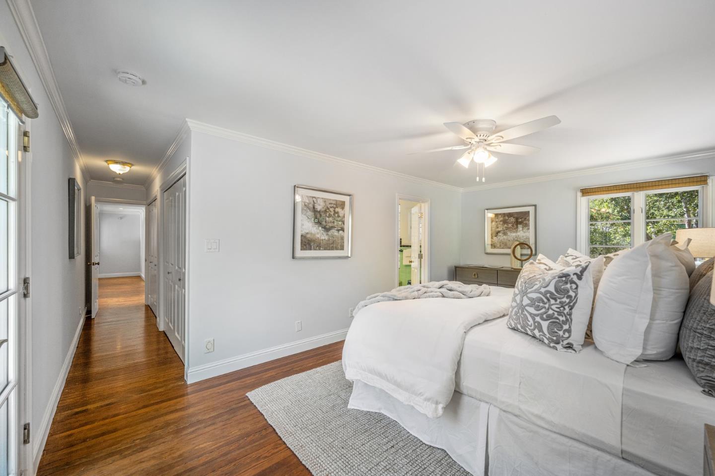 1585 Canada Lane Woodside, CA 94062 - Photo 20 of 46 a spacious bedroom with a large bed and a chandelier