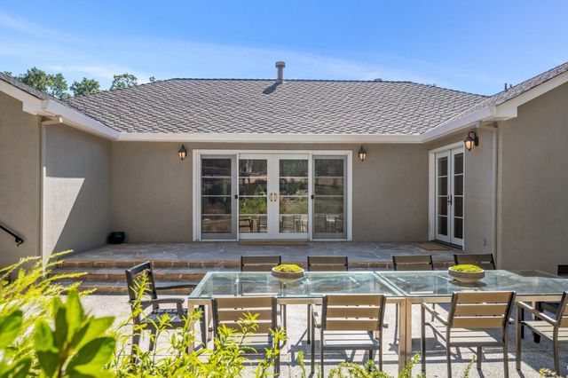 a front view of house with yard outdoor seating and patio