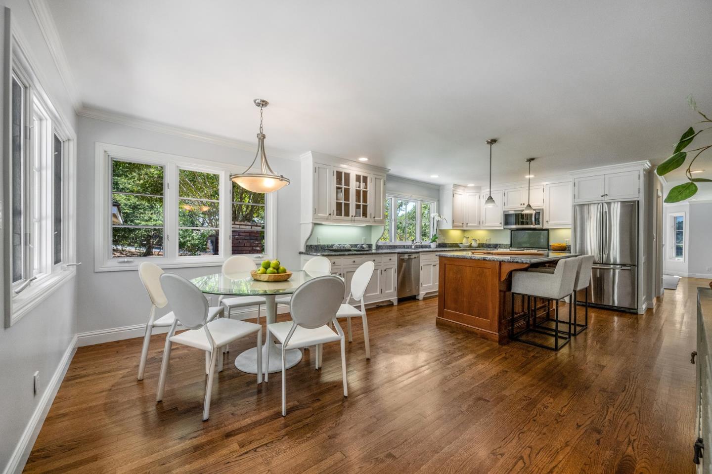 1585 Canada Lane Woodside, CA 94062 - Photo 8 of 46 a kitchen with a dining table chairs and refrigerator