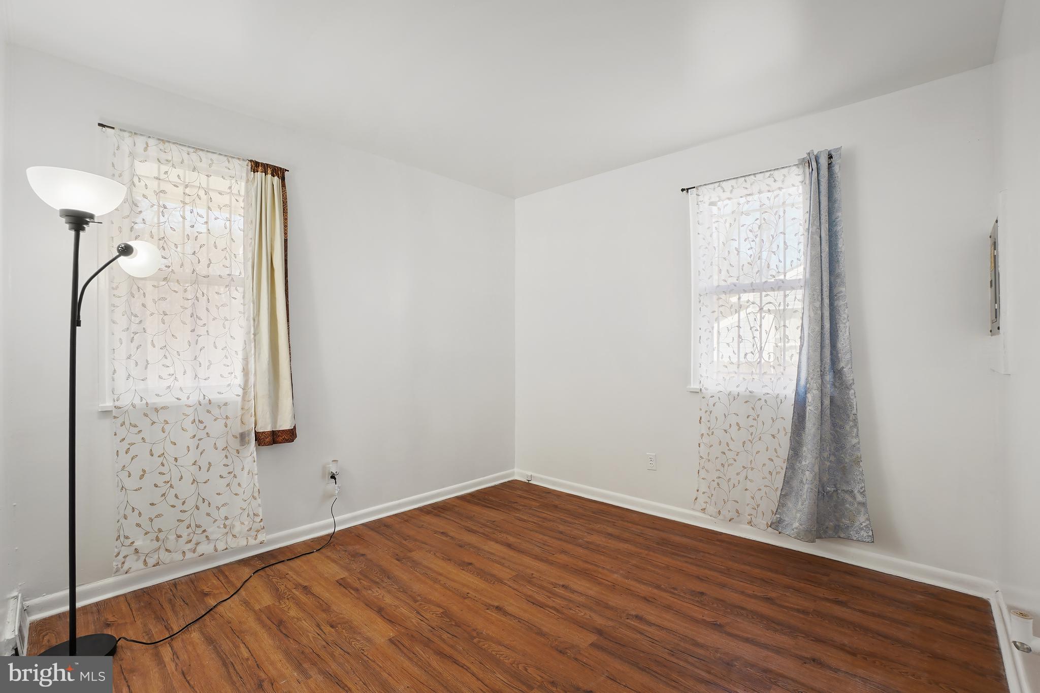 7523 Greenleaf Road Landover, MD 20785 - Photo 18 of 30 an empty room with wooden floor and a window