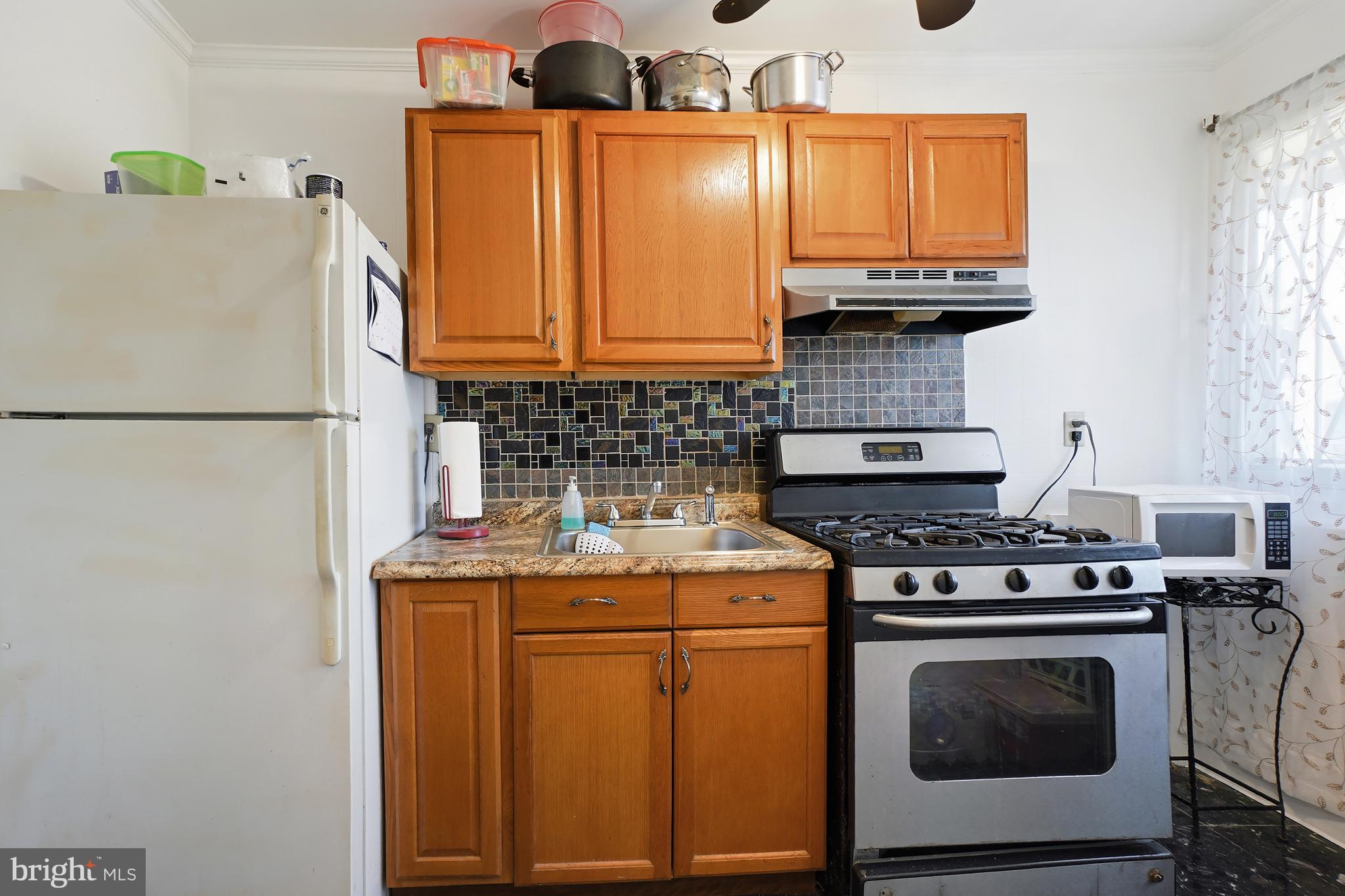 7523 Greenleaf Road Landover, MD 20785 - Photo 8 of 30 a kitchen with stainless steel appliances granite countertop a stove a refrigerator and a sink