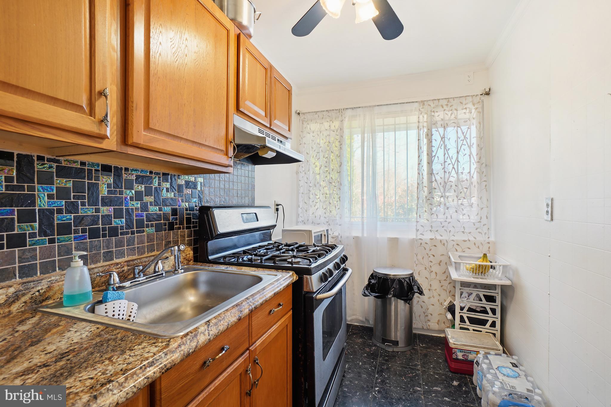 7523 Greenleaf Road Landover, MD 20785 - Photo 9 of 30 a kitchen that has a sink and a stove
