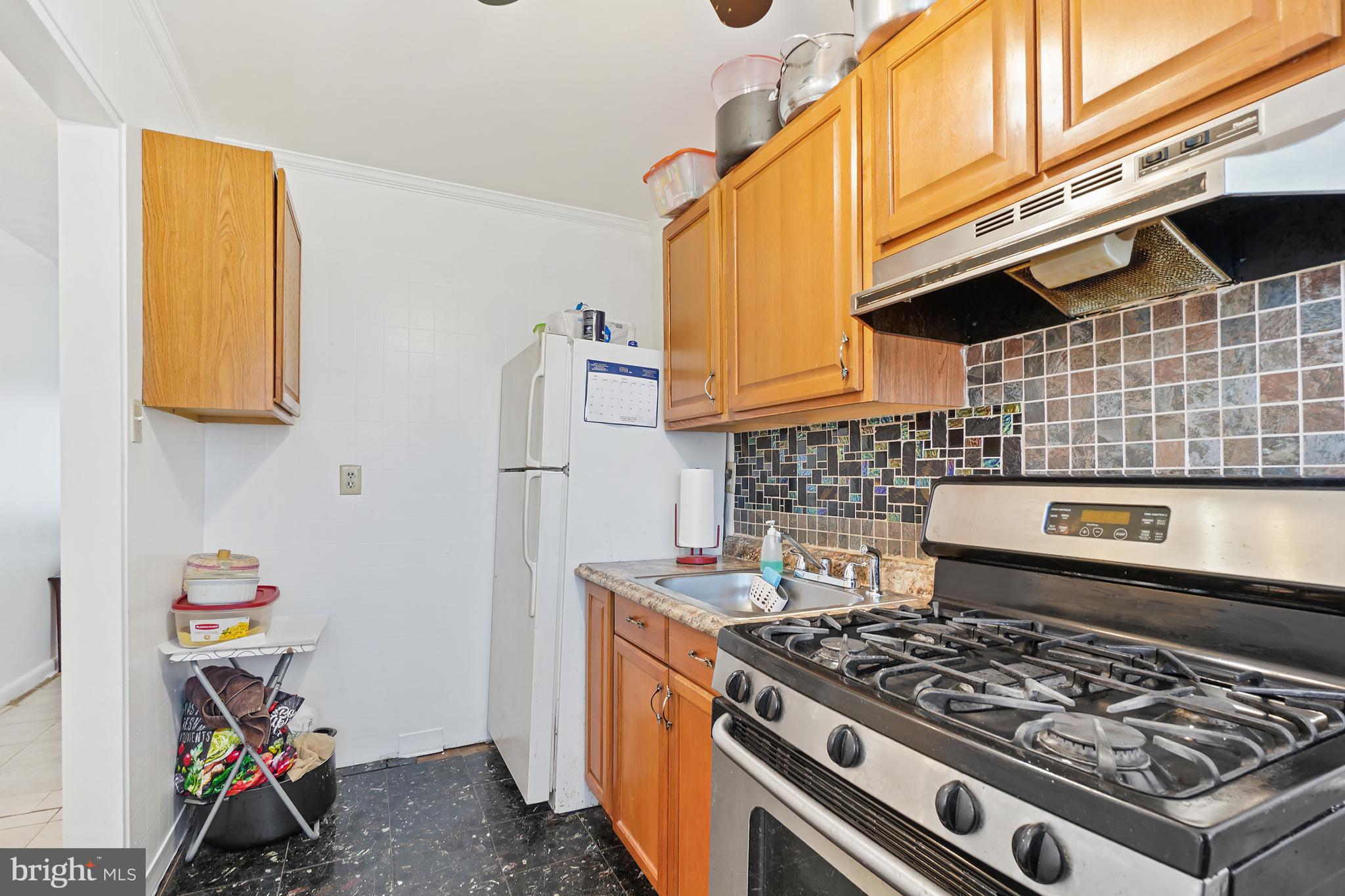 7523 Greenleaf Road Landover, MD 20785 - Photo 10 of 30 a kitchen with a stove and a sink