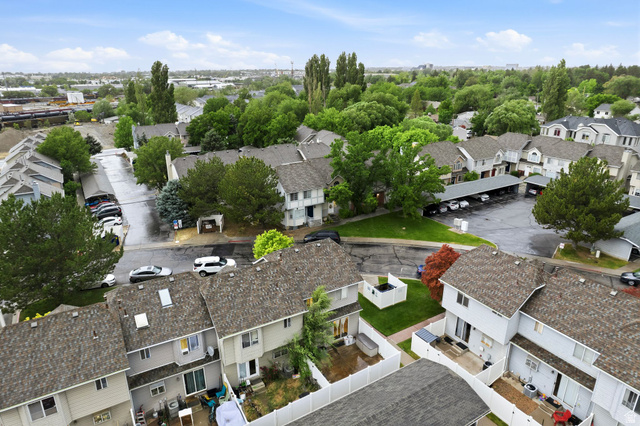 1099 South 950 East, Unit 17 Provo, UT 84606 - Photo 20 of 23 Aerial perspective showcasing a residential community with numerous two-story properties featuring shingle roofs