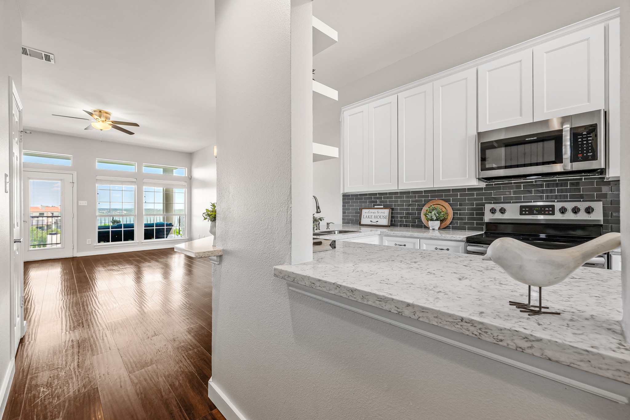2918 Ranch Road 620 North, Unit S242 Austin, TX 78734 - Photo 11 of 35 Granite counters and stainless steel appliances complete this contemporary kitchen, offering seamless flow into the sun-drenched living space.