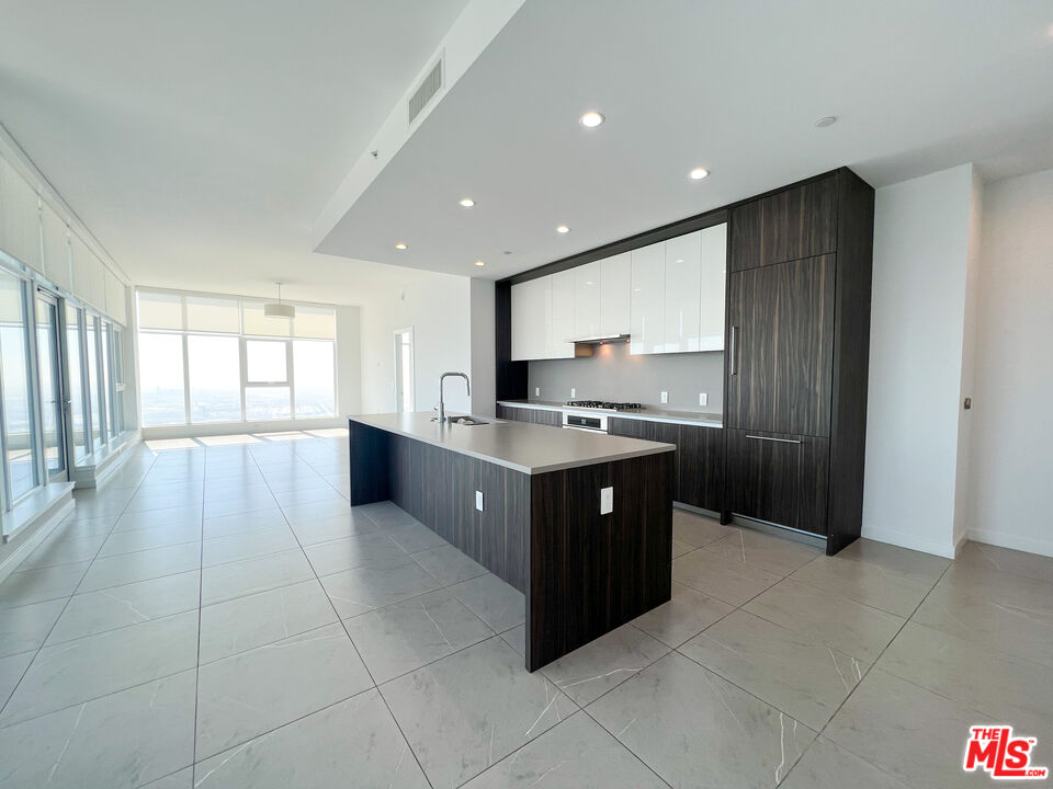 a large kitchen with a large counter top space and stainless steel appliances