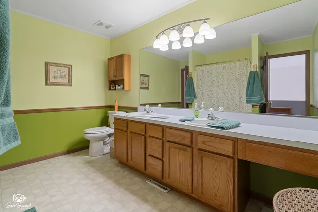 a bathroom with a double vanity sink and a mirror