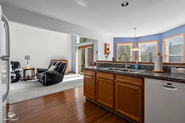 a kitchen with stainless steel appliances granite countertop a sink dishwasher a stove and a microwave oven