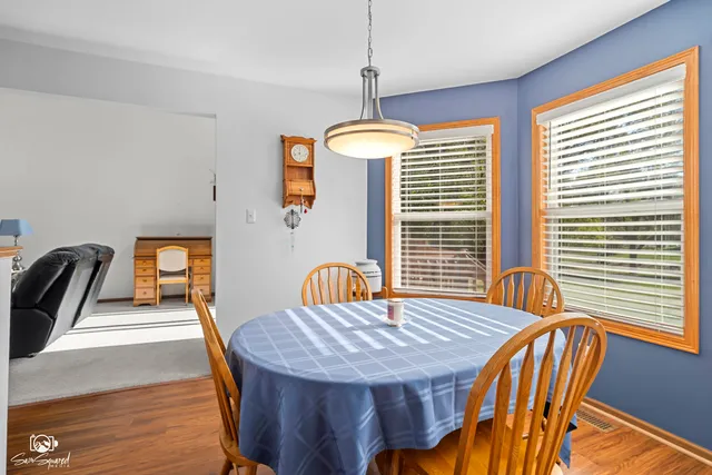 a dining room with furniture and wooden floor