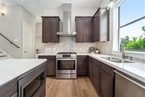 a kitchen with a sink stove and cabinets