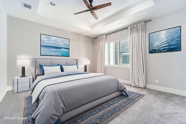 a bedroom with a bed and a painting on the wall