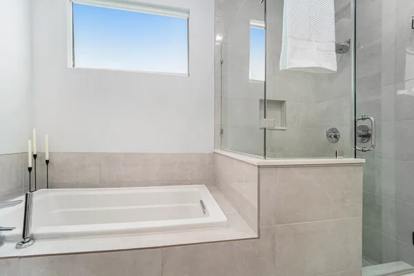a bathroom with a bathtub and shower