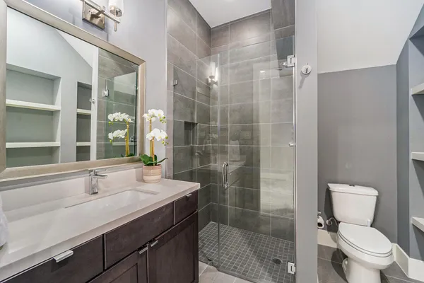a bathroom with a sink toilet and shower